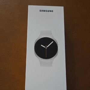 Samsung Smartwatch with White Band and Black Face
